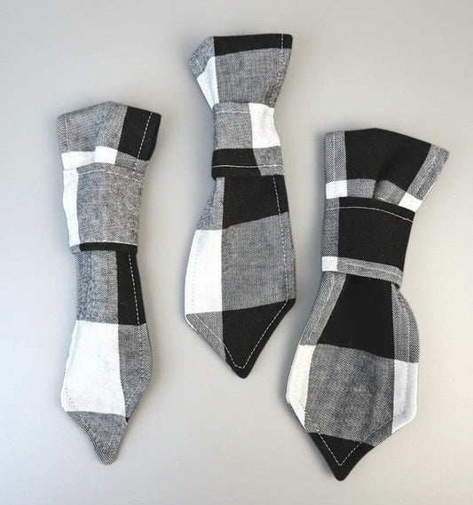 Three pairs of plaid-patterned ties on a light gray background