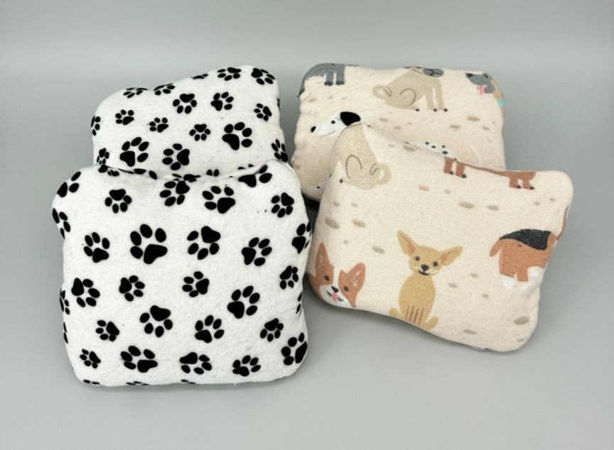 Handwarmers in dog printed cotton flannel on a grey background. 