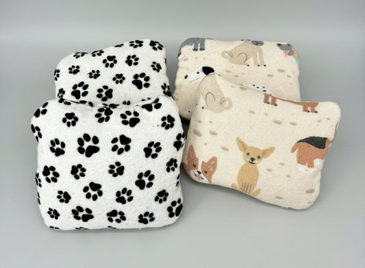 Handwarmers in dog printed cotton flannel on a grey background. 